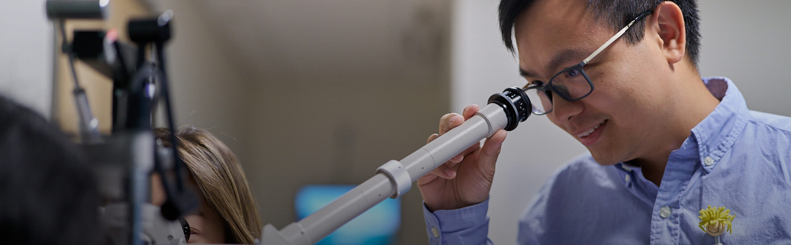 Dr. Anh V. Bui examining a patient at NECO Center for Eye Care - Commonwealth