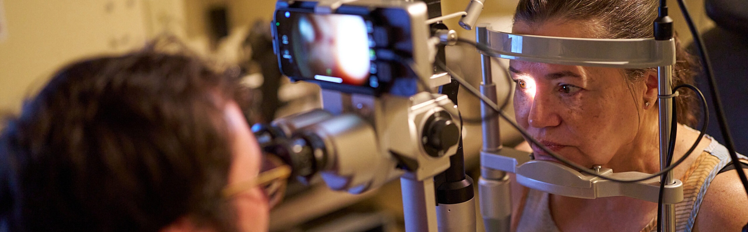 Female patient being examined by NECO student at NECO Center for Eye Care - Roslindale