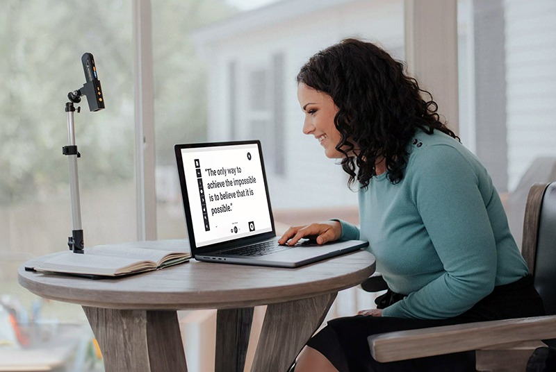 Woman using a screen reader to increase the size of text to make it easier to read