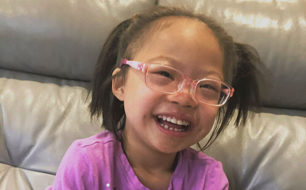 Child with glasses smiling